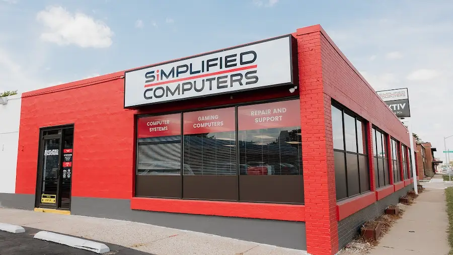 Exterior of Simplified Computers storefront with employee walking in.