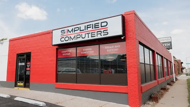 Exterior of Simplified Computers storefront with employee walking in.